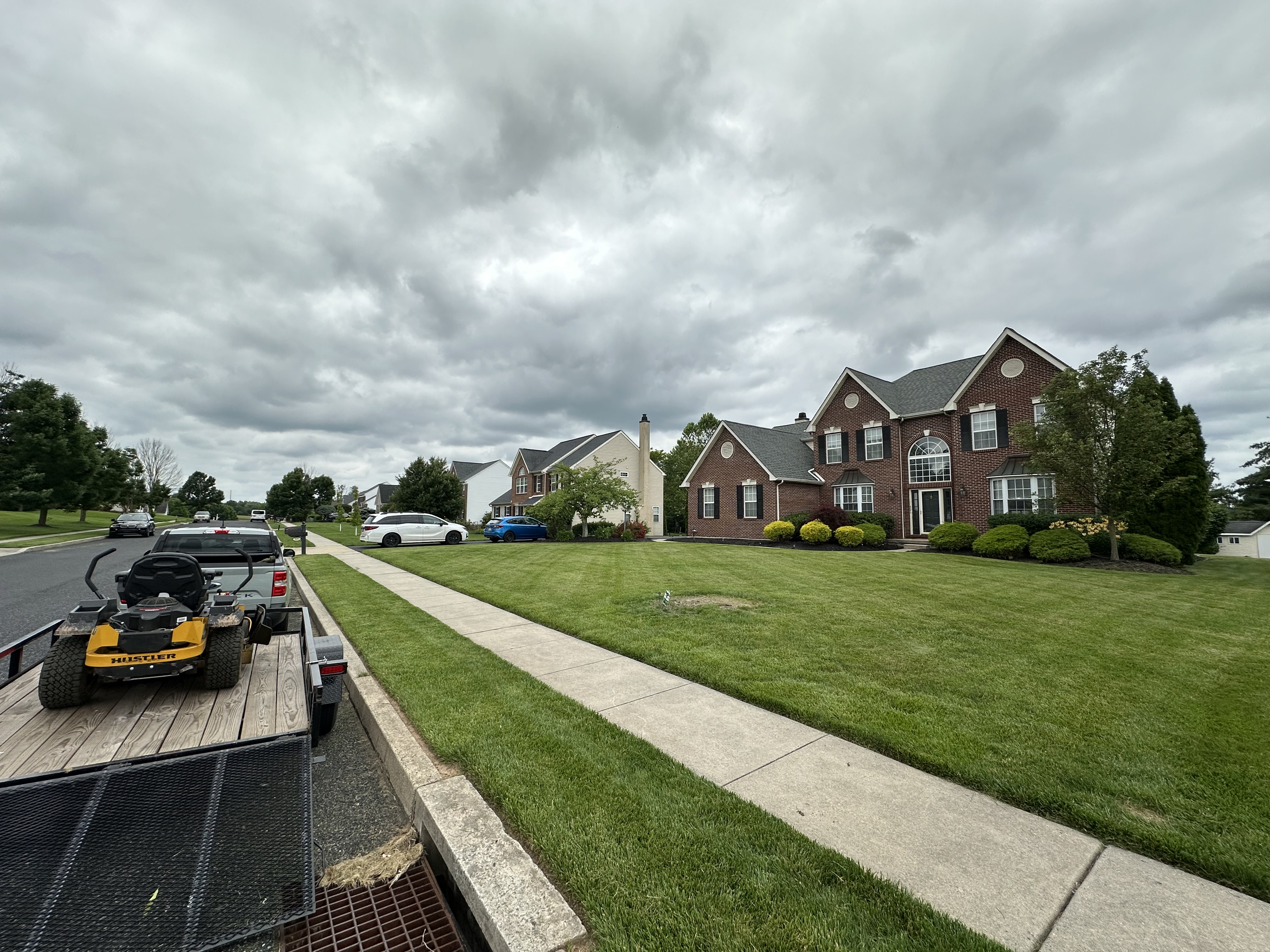 Freshly cut lawn in front of a brick house