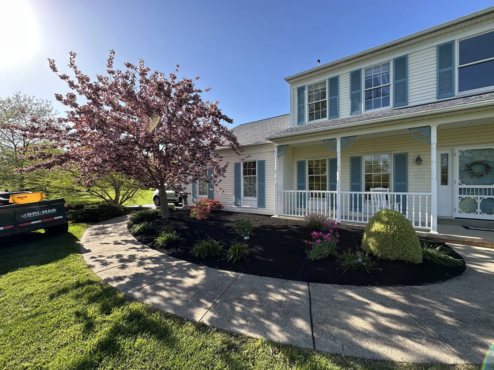 Landscaped residential property with fresh mulch and planting beds